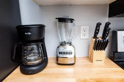 a blender sitting on top of a wooden counter at The Palms at Middle River Terrace 3 in Fort Lauderdale