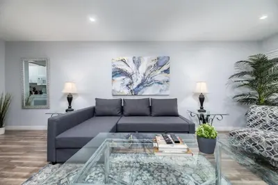 a living room with a couch and a glass table at The Palms at Middle River Terrace 2 in Fort Lauderdale