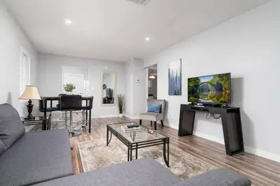 a living room with a couch and a table at The Palms at Middle River Terrace 1 in Fort Lauderdale
