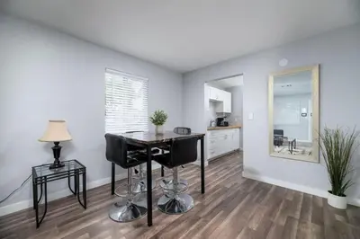a kitchen with a table and chairs in a room at The Palms at Middle River Terrace 1 in Fort Lauderdale