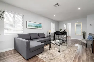a living room with a couch and a table at The Palms at Middle River Terrace 1 in Fort Lauderdale