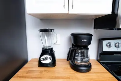 a blender sitting on a counter next to a coffee maker at The Palms at Middle River Terrace 4 in Fort Lauderdale
