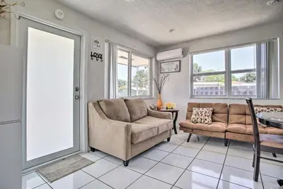 a living room with a couch and a chair at Fort Lauderdale Duplex about 5 Mi to Downtown! in Fort Lauderdale