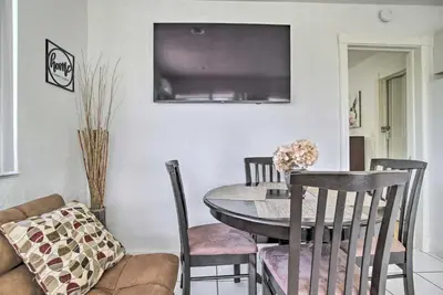 a dining room with a table and chairs and a tv at Fort Lauderdale Duplex about 5 Mi to Downtown! in Fort Lauderdale