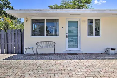 a bench sitting in front of a white house at Fort Lauderdale Duplex about 5 Mi to Downtown! in Fort Lauderdale