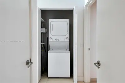 a kitchen with a washer and dryer in a room at Penthouse Condo at Lyfe Resort and Residences in Hollywood