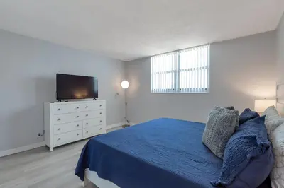 a bedroom with a bed and a flat screen tv at Great apartment in Hollywood with side ocean view! Direct access to the beach! 14th floor in Hollywood