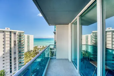 an apartment balcony with a view of the ocean at Great apartment in Hollywood with side ocean view! Direct access to the beach! 14th floor in Hollywood