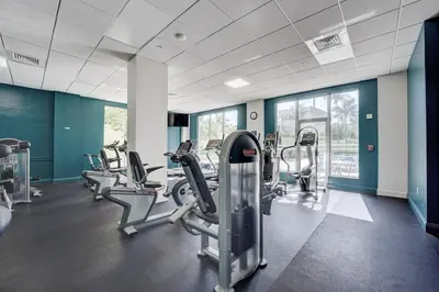 a gym with treadmills and elliptical machines at Great apartment in Hollywood with side ocean view! Direct access to the beach! 14th floor in Hollywood