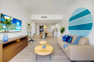 a living room with a couch and a surfboard on the wall at Amazing Pool - Balcony - Up To 6 - Near Beach in Hollywood