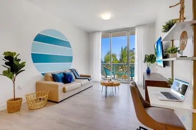 a living room with a couch and a desk with a laptop at Amazing Pool - Balcony - Up To 6 - Near Beach in Hollywood