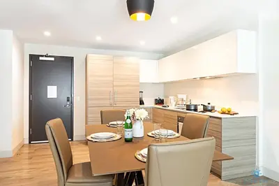 a kitchen and dining room with a table and chairs at Rooftop Pool, Broad-walk & Near Beach in Hollywood