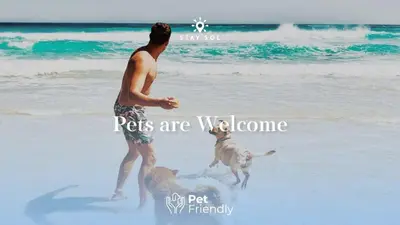a man and a dog playing on the beach at Rooftop Pool, Broad-walk & Near Beach in Hollywood