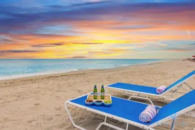 a picnic table on the beach with bottles of beer at Rooftop Pool, Broad-walk & Near Beach in Hollywood