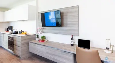 a kitchen with a desk with a tv on a wall at 5 Tropical Oasis ROOFTOP infinity POOL Hot Tub on Hollywood Boardwalk in Hollywood