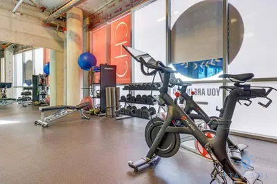 a gym with a bike parked in a room at 5 Tropical Oasis ROOFTOP infinity POOL Hot Tub on Hollywood Boardwalk in Hollywood