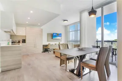 a kitchen and dining room with a table and chairs at Rooftop Pool - Hot Tub - Gym - Near Beach in Hollywood