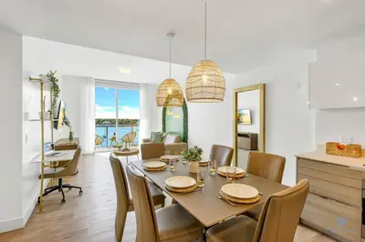 a dining room and living room with a table and chairs at Hollywood Beach - Front Bay View - Amazing Pool in Hollywood