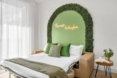 a bedroom with a bed with a green wall at Hollywood Beach - Front Bay View - Amazing Pool in Hollywood