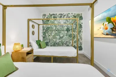 a bedroom with two beds and a painting on the wall at Hollywood Beach - Front Bay View - Amazing Pool in Hollywood