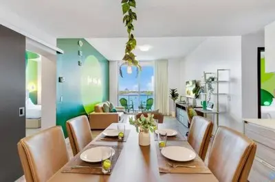 a dining room with a long table and chairs at Lovely Apartment-Rooftop Oasis - Bay View in Hollywood