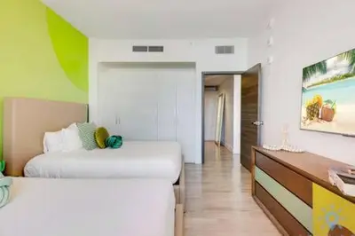 a room with two beds and a dresser in it at Lovely Apartment-Rooftop Oasis - Bay View in Hollywood