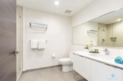 a white bathroom with a toilet and a sink at Rooftop Pool - Hot Tub - Hollywood Beach Broad - walk in Hollywood