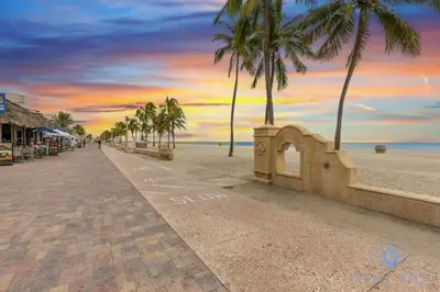 a street with palm trees on a beach with a sunset at Rooftop Pool - Balcony - Hollywood Beach - Gym in Hollywood