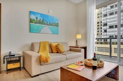 a living room with a couch and a table at Rooftop Pool - Balcony - Hollywood Beach - Gym in Hollywood