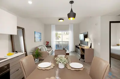 a kitchen and living room with a table and chairs at Rooftop Pool - Balcony - Hollywood Beach Boardwalk in Hollywood