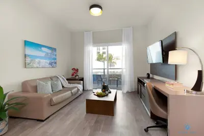 a living room with a couch and a flat screen tv at Rooftop Pool - Balcony - Hollywood Beach Boardwalk in Hollywood