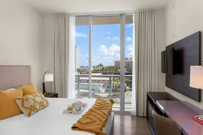 a hotel room with a bed and a large window at Balcony - Hollywood Beach Broad-walk - Rooftop Pool in Hollywood
