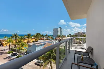 a balcony with a view of a city and the ocean at Balcony - Hollywood Beach Broad-walk - Rooftop Pool in Hollywood