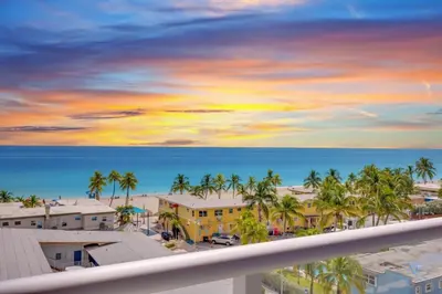 a view of the ocean from the balcony of a resort at Ocean View Balcony - Rooftop Pool & Hot Tub - Gym in Hollywood