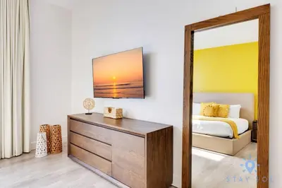a bedroom with a bed and a mirror and a dresser at Lovely Apartment - Hollywood Beach - Rooftop Pool in Hollywood