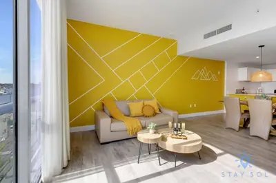 a living room with a couch and a table at Lovely Apartment - Hollywood Beach - Rooftop Pool in Hollywood