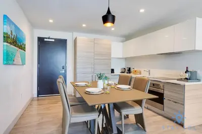 a kitchen with a table and chairs in a kitchen at Ocean View - Balcony - Rooftop Pool - Hollywood Beach in Hollywood