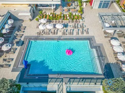 an overhead view of a swimming pool with chairs and umbrellas at Ocean View - Balcony - Rooftop Pool - Hollywood Beach in Hollywood