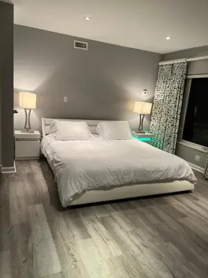 a bedroom with a large white bed and two lamps at WaterFront 4BR 3B,Intercoastal,Pool,5 min walk to beach-7 in Fort Lauderdale
