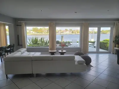 a living room with a white couch and a large window at WaterFront 4BR 3B,Intercoastal,Pool,5 min walk to beach-7 in Fort Lauderdale