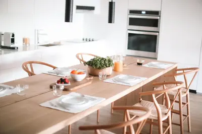 a kitchen with a wooden table and chairs at Beach Haus Residences in Bal Harbour