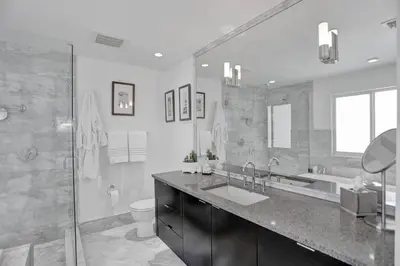 a bathroom with a sink and a tub and a toilet at Hollywood Villa close to the BEACH w/HEATED POOL in Hollywood