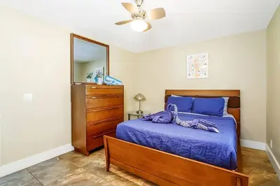 a bedroom with a bed and a dresser and a mirror at Hollywood Villa close to the BEACH w/HEATED POOL in Hollywood