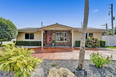 a house with a palm tree in front of it at Hollywood Villa close to the BEACH w/HEATED POOL in Hollywood