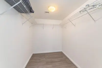 an empty room with white walls and wood floors at 4BR APT with Bay View at Brickell, Free Parking in Miami
