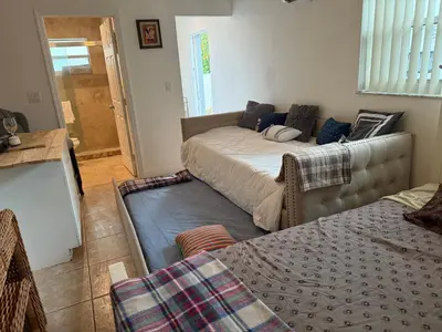a room with two beds and a couch in it at El Shaddai Faithfully Beach in Hollywood