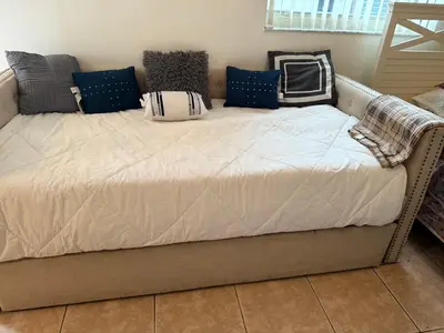 a bed with pillows on it in a room at El Shaddai Faithfully Beach in Hollywood