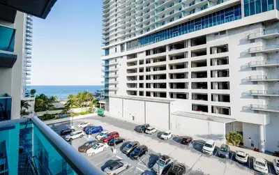 an aerial view of a parking lot in front of a building at Beautiful 2 Bedroom Apartment on Hollywood Beach in Hollywood