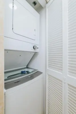 a white kitchen with a stove and a door at Amazing 2 BR APT at Brickell, Free Parking in Miami