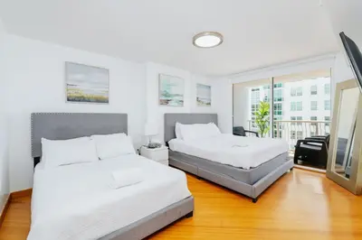 a bedroom with two beds and a balcony at Amazing 2 BR APT at Brickell, Free Parking in Miami